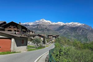 an empty road with snow capped mountains in the background at Casa Belvedere in Gravere