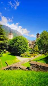 a view of a green field with buildings and trees at Casa Belvedere in Gravere