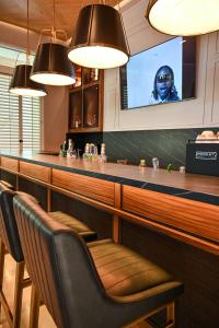 a bar with two chairs and a television at Moka Boutique Hotel in Torreón +52 photos