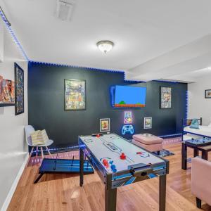 a room with a ping pong table in it at Retro Arcade & Gaming Home by Pako Stays in Brampton