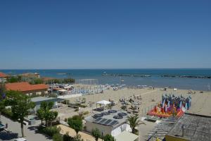 a beach with umbrellas and people on the beach at Hotel Villa Boschetti in San Mauro a Mare