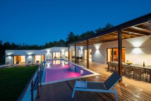 a house with a swimming pool at night at Villa Istria Green in Kršan