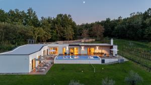a house with a pool and a backyard at Villa Istria Green in Kršan