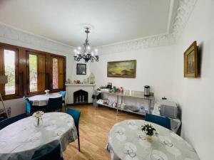 a living room with two tables and a fireplace at Casa Torino in Santiago