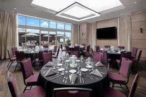 a conference room with tables and chairs and a screen at San Diego Marriott Del Mar in San Diego