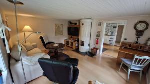 Posezení v ubytování Lidsbergs torp i Ölme från år 1910 Ett eget mysigt torp med kakelugn, lågt i tak, sovrum med dubbelsäng och 2 enkelsängar på loft med snedtak bäddsoffa i v-rum trädgård med gasgrill