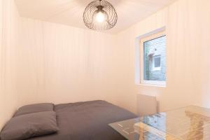 a bedroom with a bed and a glass table at LE 23 Bis in Jarny