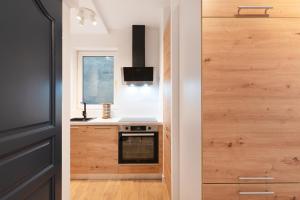 a kitchen with a stove and a window and a door at LE 23 Bis in Jarny +5 photos
