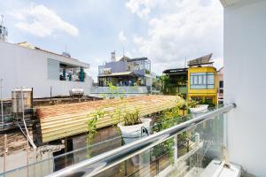 a balcony with plants on top of a building at Happy house studio in Ho Chi Minh City