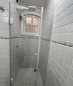 a shower with a glass door in a bathroom at Casa da Lua Centro in Búzios +43 photos
