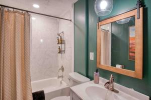 a bathroom with a sink and a toilet and a mirror at Castle Steet Retreat - The Rustic Whiskey in Wilmington +21 photos