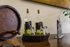 a couple of bottles of wine on a table at Pousada Encanto de Tiradentes in Tiradentes +54 photos