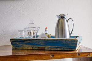 a blue wooden box with a tea kettle on a table at Pousada Encanto de Tiradentes in Tiradentes