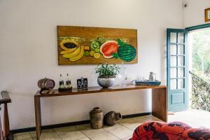 a counter in a kitchen with a painting on the wall at Pousada Encanto de Tiradentes in Tiradentes