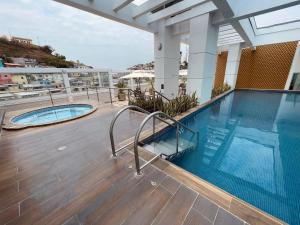 a swimming pool on the roof of a building at Gallery Suite en Riverfront Puerto Santa Ana in Guayaquil