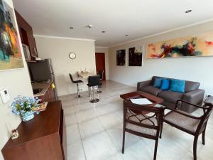 a living room with a couch and a table at Gallery Suite en Riverfront Puerto Santa Ana in Guayaquil