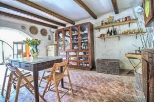a kitchen with a table and chairs in a room at La Tavernetta in Santa Venerina