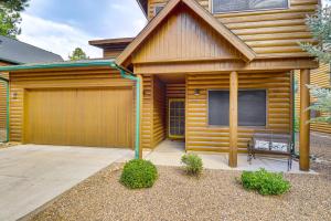 a wooden house with a garage and a bench at Pinetop Lakes Golf Club Cabin with Central AandC in Pinetop