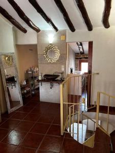 a room with a kitchen with a sink and a mirror at Rural Stone House with wood fireplace in Pinell de Bray
