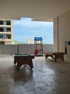 two ping pong tables in a room with a playground at Bello Horizonte-sector Hilton -irotama in Playa Bello Horizonte
