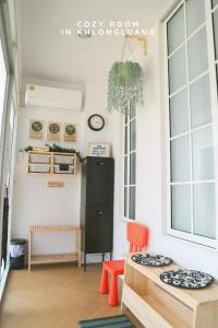a small kitchen with a black refrigerator and orange chairs at Cozy room in Khlongluang - Self Check-in in Khlong Luang +91 photos