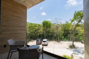 a view from the balcony of a house with a car park at Top Location Studio with Rooftop Pool, Gym and Padel Court in Tulum