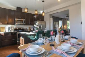 a kitchen and dining room with a table and chairs at Fam-Biz Friendly 3BD with Fire pit & BBQ - Downtown in Raleigh