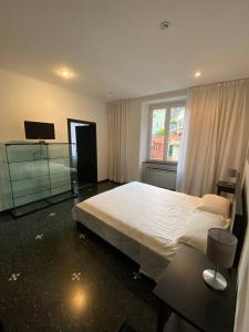 a bedroom with a large white bed and a window at Martel Rooms - Genova Centro Brignole in Genova +83 photos