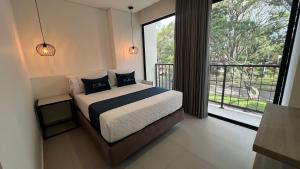 a bedroom with a bed and a large window at Hotel ECO 44 in Medellín