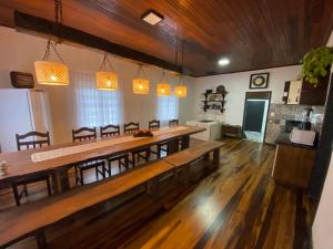 a large dining room with a long table and chairs at Sítio Nono Luiz in Benedito Novo
