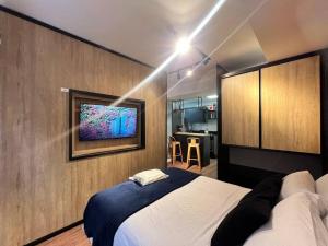Ένα ή περισσότερα κρεβάτια σε δωμάτιο στο Studio Lounge Impecável Novo