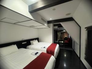 Postel nebo postele na pokoji v ubytování EN Hotel Shibuya