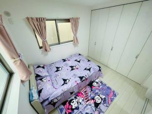 Postel nebo postele na pokoji v ubytování 糖果屋 岸里玉出