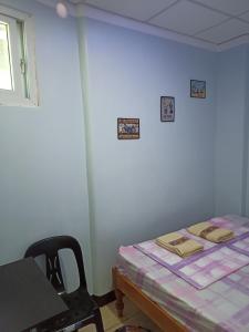 a room with a bed and a table and a window at Sky Beach budget rooms in Catmon +8 photos