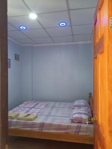 a bedroom with a bed in a room at Sky Beach budget rooms in Catmon