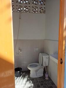 a bathroom with a toilet and a bath tub at Sky Beach budget rooms in Catmon