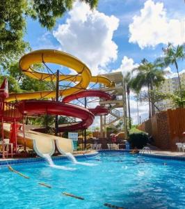 a water slide in a pool at a resort at Golden Dolphin Supreme in Caldas Novas