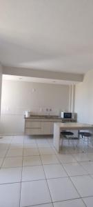 a large white room with a table and a kitchen at Golden Dolphin Supreme in Caldas Novas +10 photos