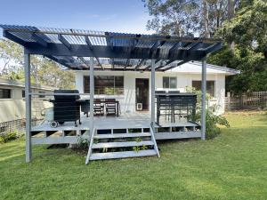 a pergola with a grill in a yard at Pet-Friendly 2-Bed Beach House with Garden & BBQ in Surf Beach