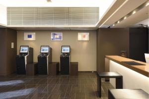 a lobby with three atm machines on the wall at Hakata Green Hotel Annex in Fukuoka