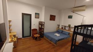 a bedroom with a bed and a chair and a mirror at Phe's House in Da Nang