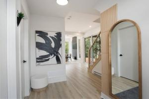 a hallway with a mirror and an archway in a house at Ultra Luxurious Modern Chalet Private Jacuzzi in La Conception +109 photos