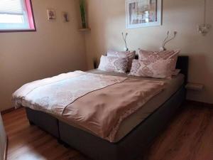 a large bed in a bedroom with pillows on it at Ranchhouse Dogs and horses welcome in Aurich