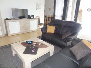 a living room with a couch and a coffee table at Eul K3 completely fenced in Großwürden