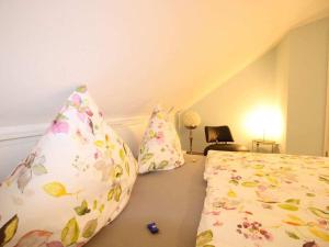 a bedroom with a bed and two pillows at Coastal House Wremen in Wremerbüttel