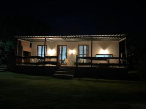 a small house at night with the lights on at Casa chacra campo en victoria entre rios in Victoria
