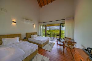 a hotel room with two beds and a balcony at La Casa Lindula Villa Ceylon in Lindula +32 photos
