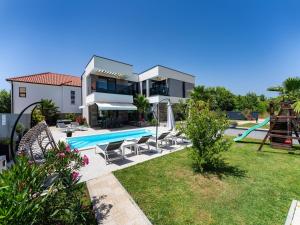 a villa with a swimming pool and a house at Villa Nina in Croatia near the Adriatic Coast in Zaton