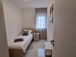 a small bedroom with a bed and a window at Villa Taya Comfortable holiday residence in Sveti Petar u Šumi +33 photos