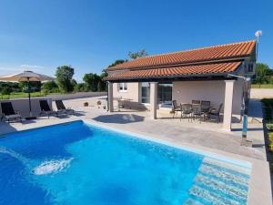 a swimming pool in front of a house at Villa Taya Comfortable holiday residence in Sveti Petar u Šumi